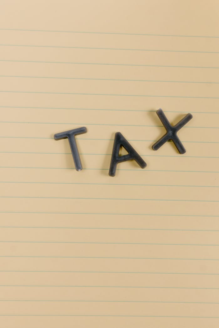 Conceptual still life image with the word Tax on lined paper, perfect for financial themes.