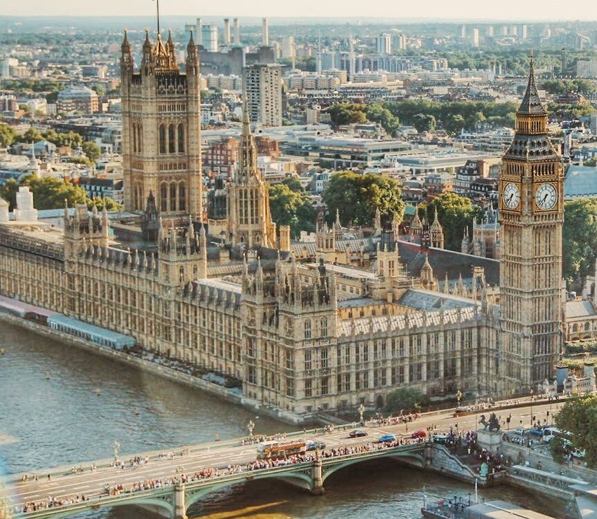 Stunning aerial view of Londons iconic Big Ben and the river Thames under daylight.